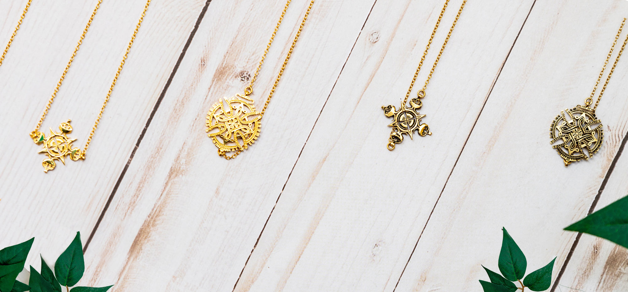 Yenae Ethiopian Cross Collection layed out, 14K gold plated necklaces