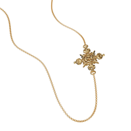 Gold cross necklace with sunburst center and small dangling charms