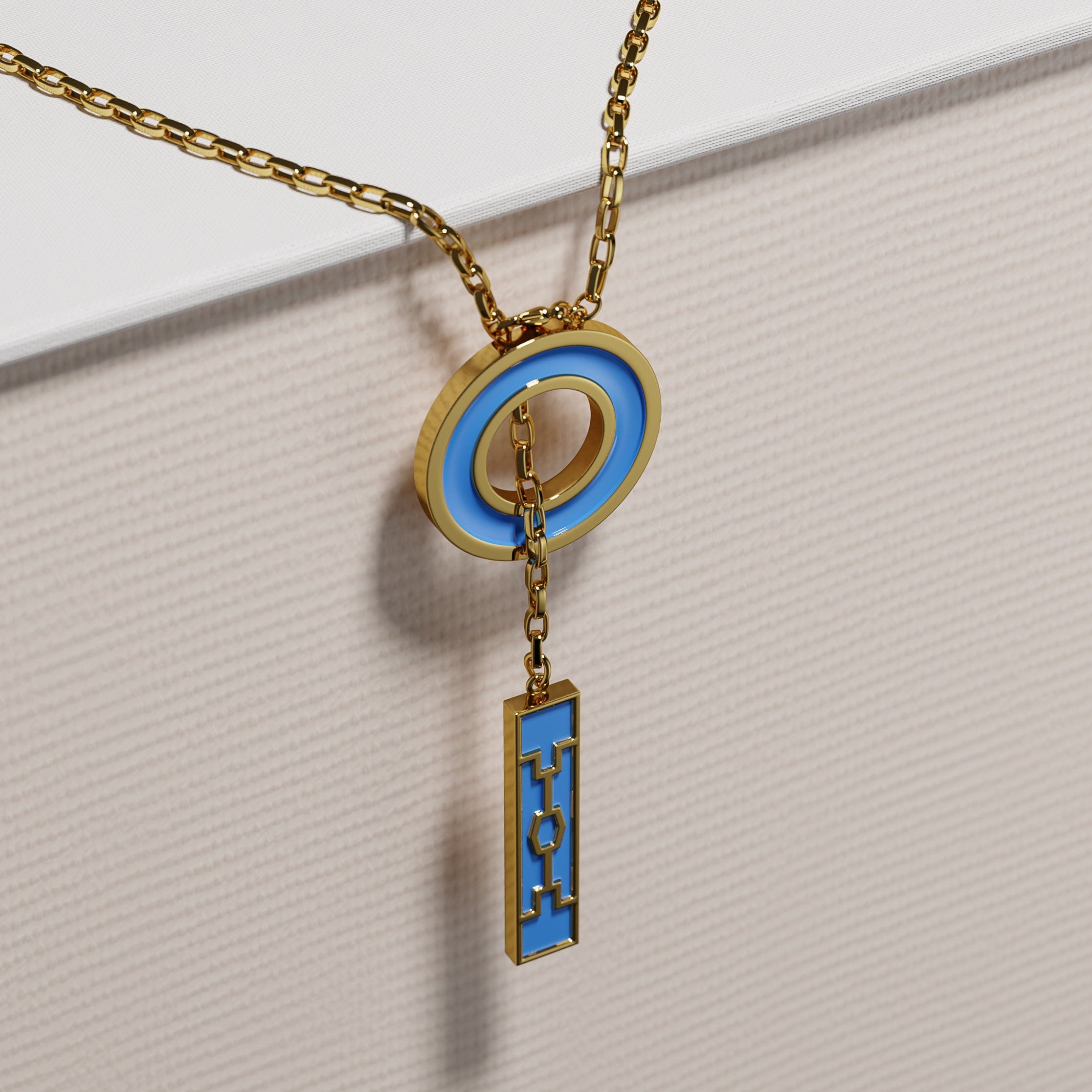 Gold-plated Ndebele necklace with navy-blue circular pendant and long rectangular charm